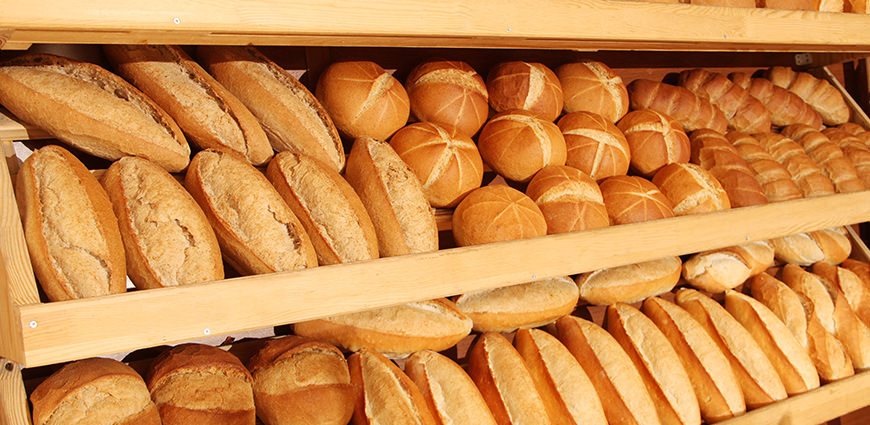 Shelf full of loaves of bread
